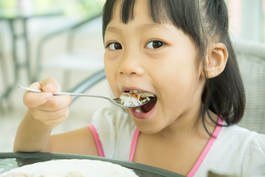 Girl 1 Eating Shutterstock 439575172